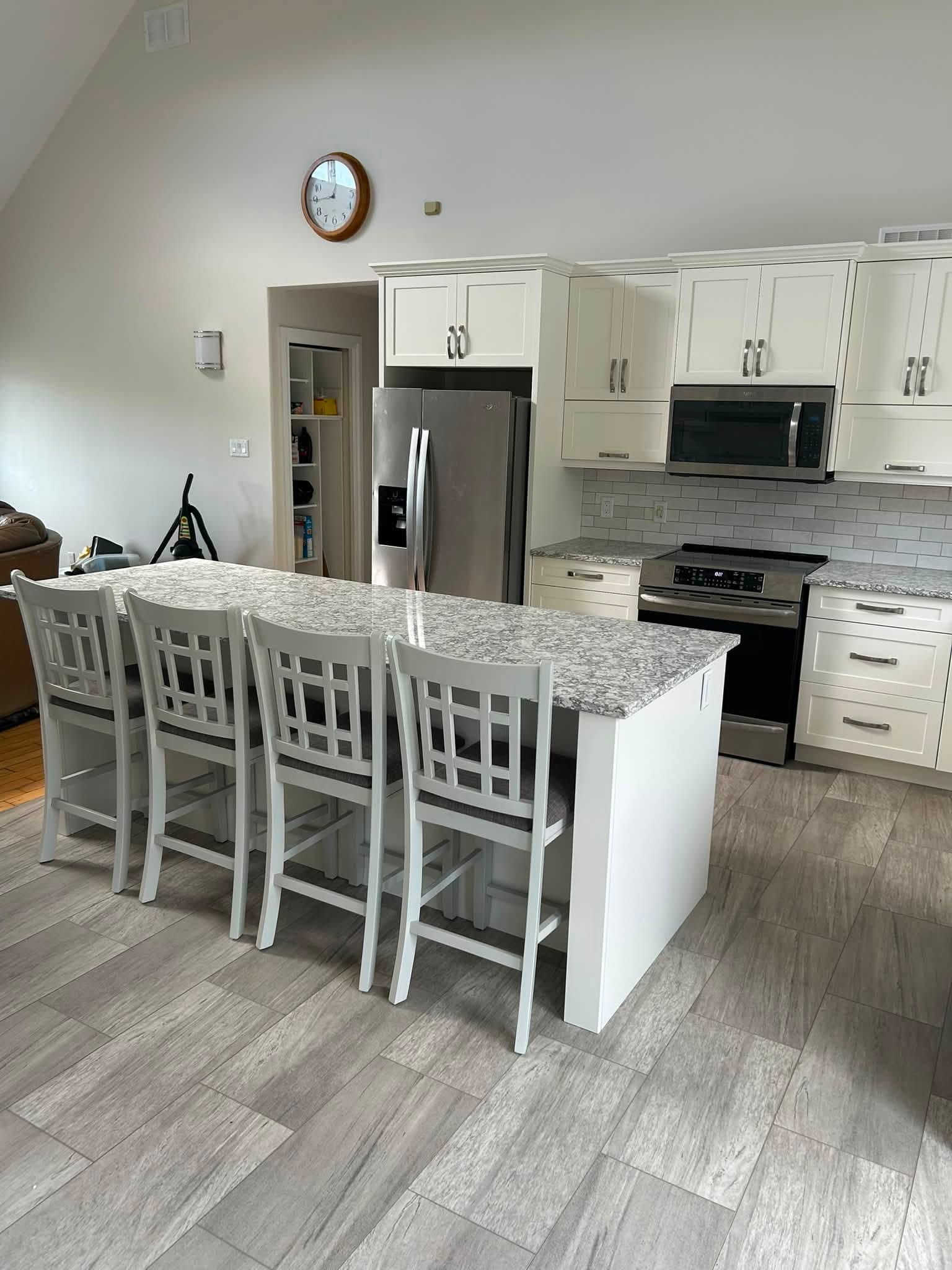 Wood Effects kitchen renovation with white cabinetry and an island