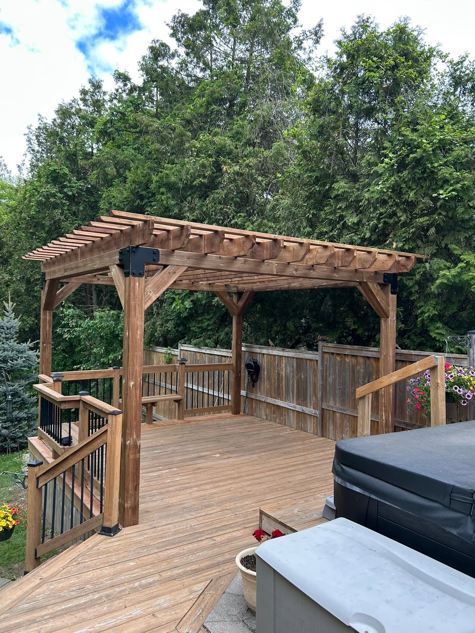 Timber pergola above a deck with wood railings.